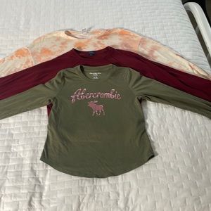 3 long sleeve girls shirts, 1 Old Navy, 1 Abercrombie kids, 1 daytrip